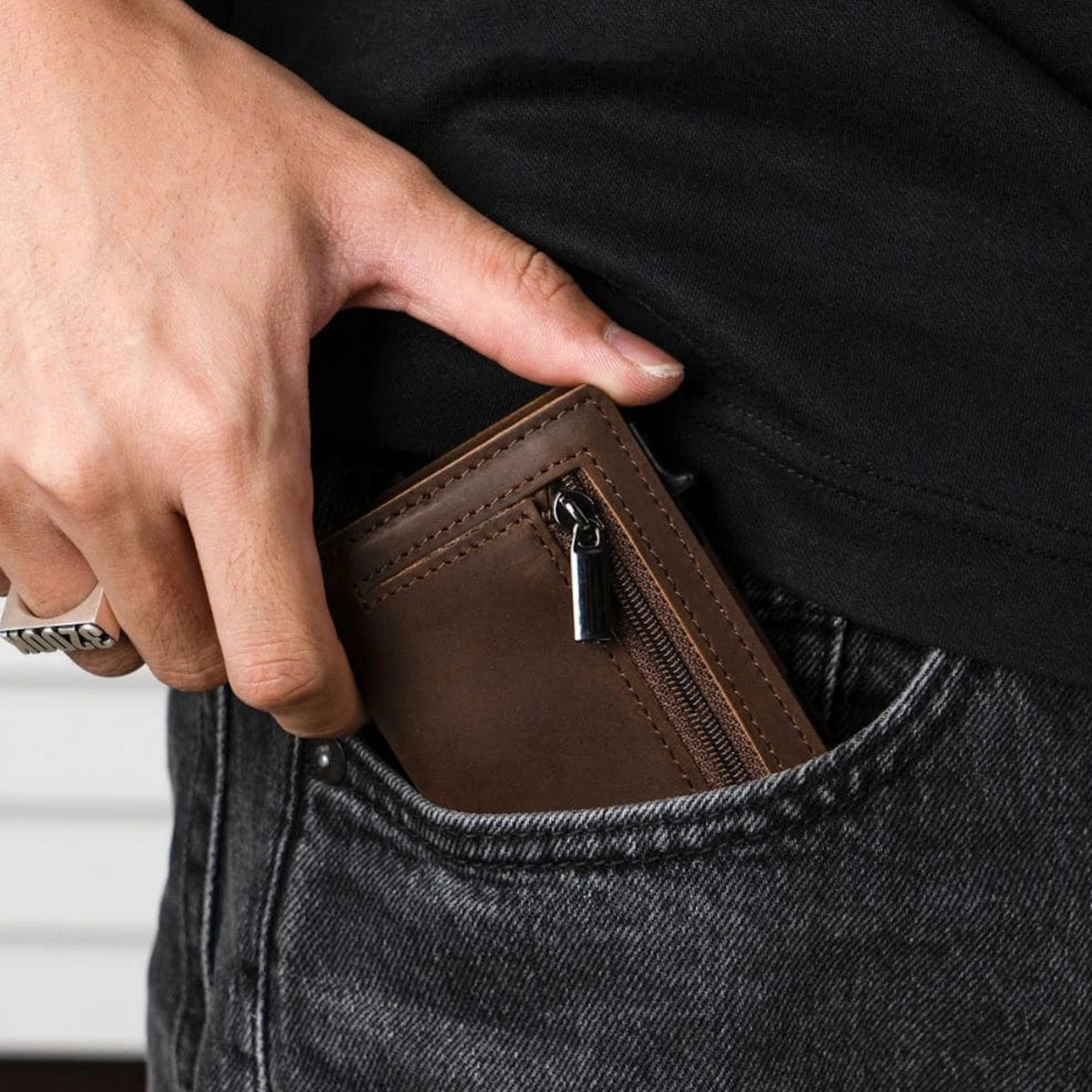 Brown wallet being pulled from a back pocket
